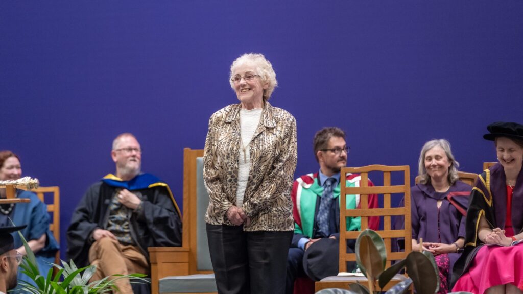 Sandra Freeman standing on stage at a graduation ceremony.