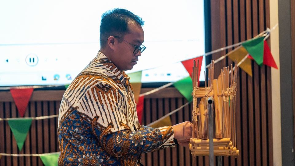 A person playing a wooden instrument at the 