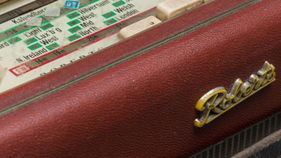 An old Roberts dark red leather radio with country names on the top