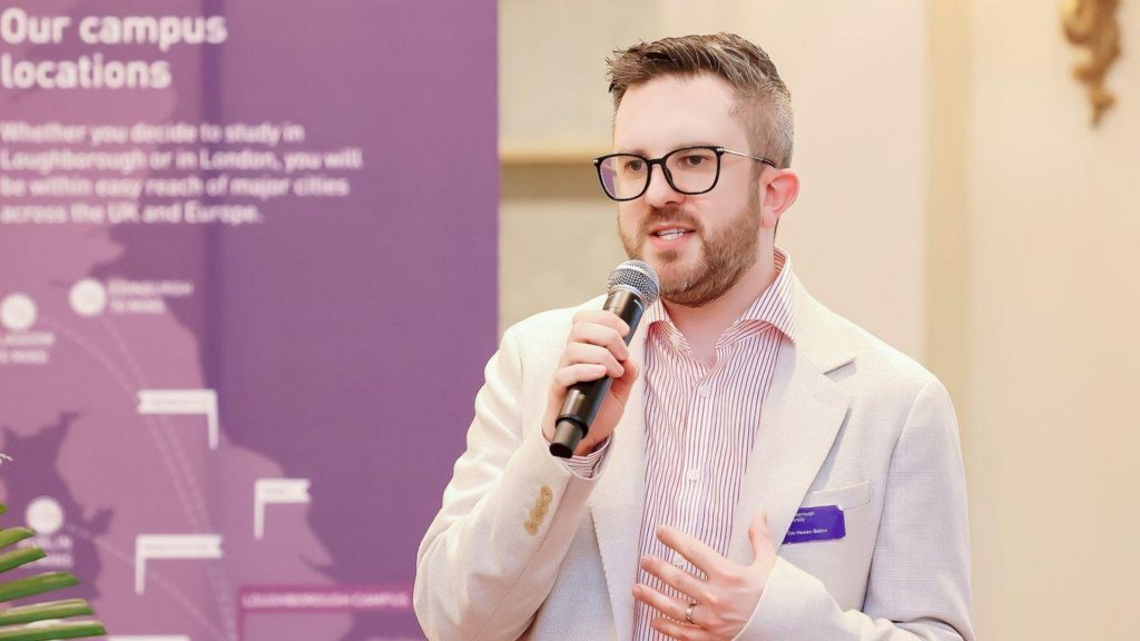 Close-up of Tim Hewes-Belton speaking into a microphone.