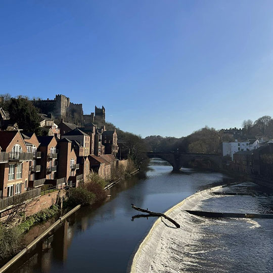 A view of Durham Cathedral and the River Wear on a sunny winter day