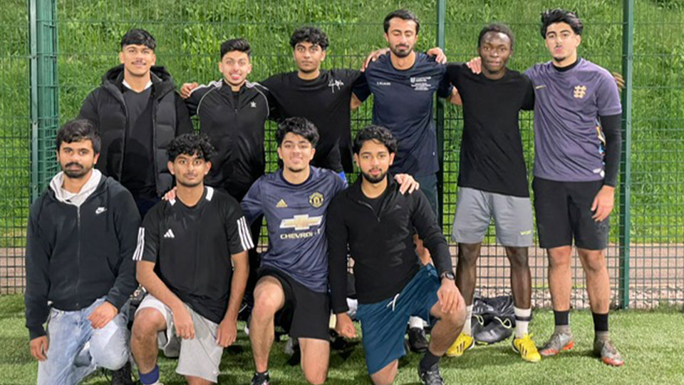 A group of young men in football outfits posing for a team photograph