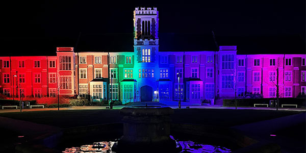 The Hazlerigg building lit up with rainbow lights.