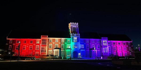 Hazlerigg building illuminated by rainbow lights