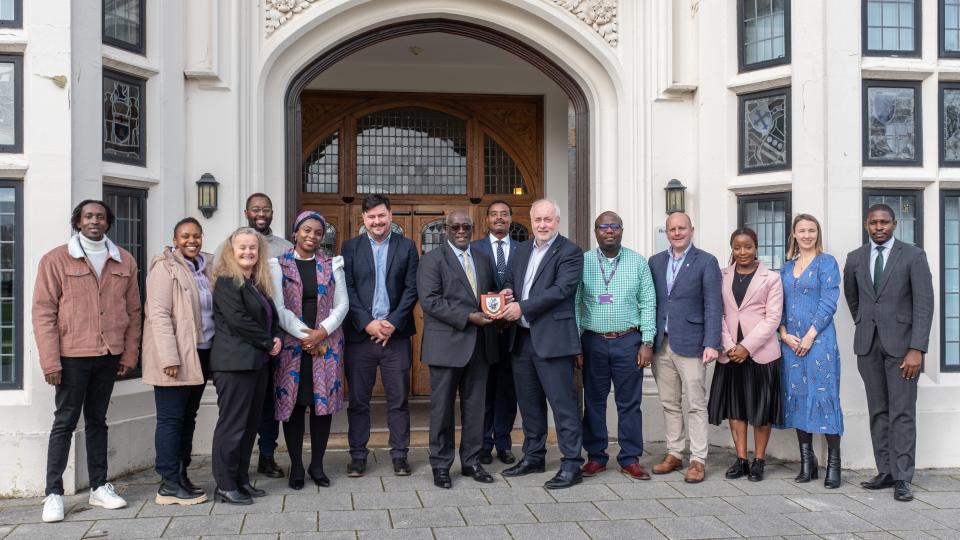 Vice Chancellor and colleagues stood with the High Commissioner of Kenya and his delegation in front of the Hazlerigg Building entrance outside.