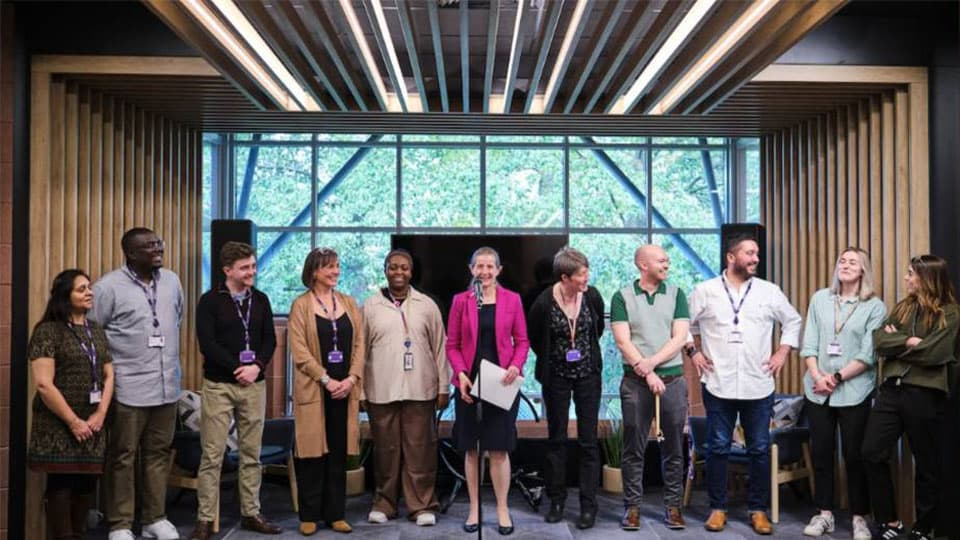 Loughborough university professionals on a stage in an event space