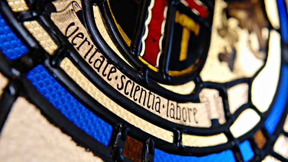 Stained glass in Hazlerigg building with University motto 'vertitate scientia labore'
