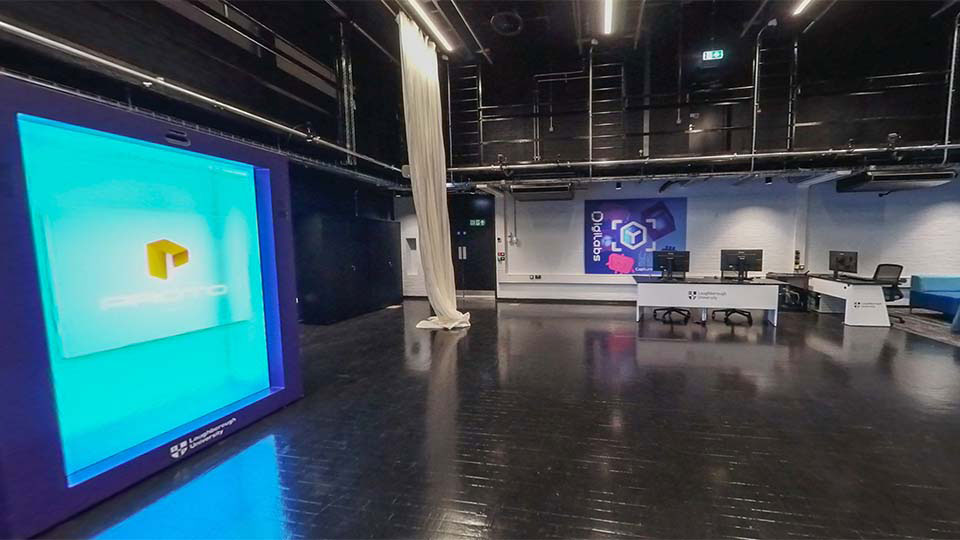 Space in existing Digilab East with large screens and a desk