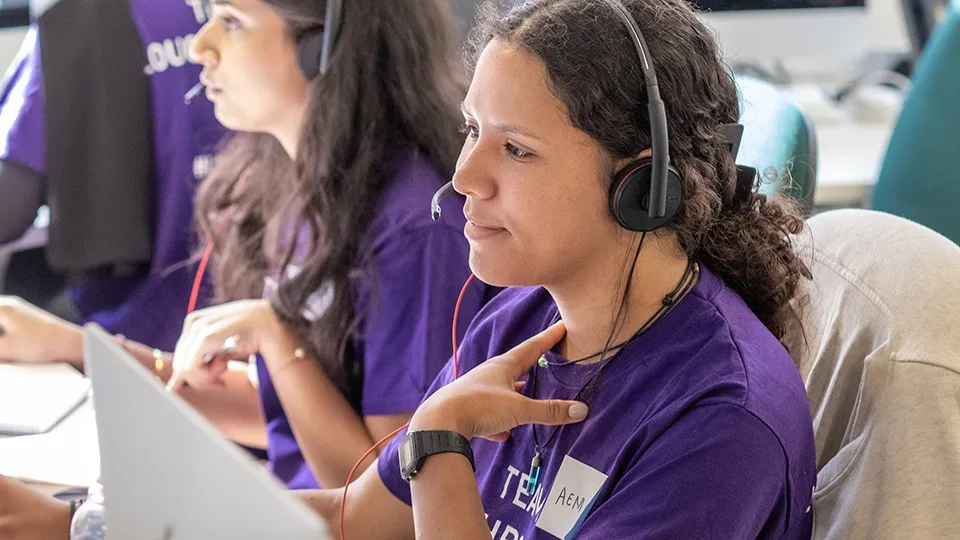 Clearing volunteers wearing headsets and purple Loughborough T-shirts