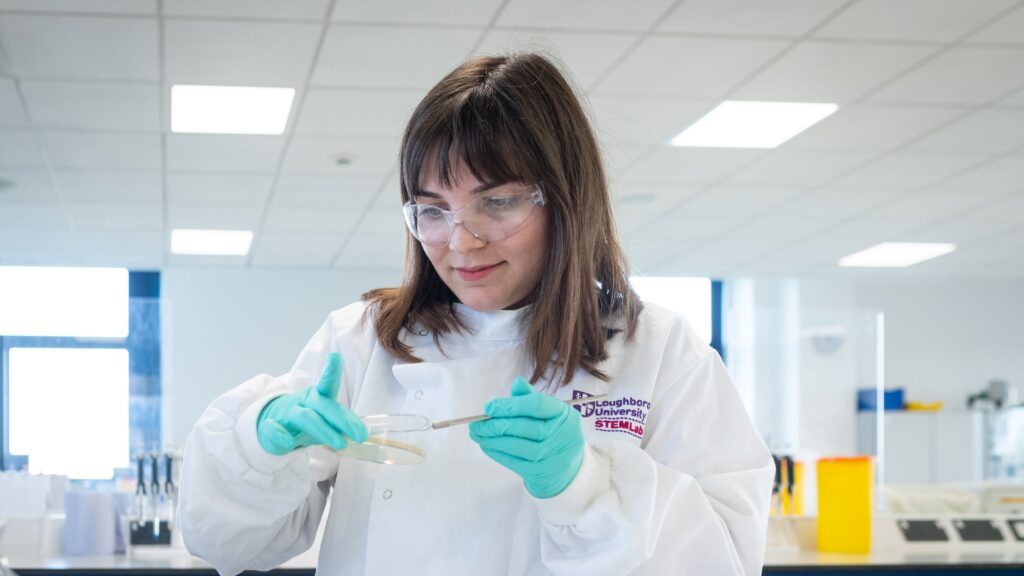 A female student conducting an experiment in the bio labs