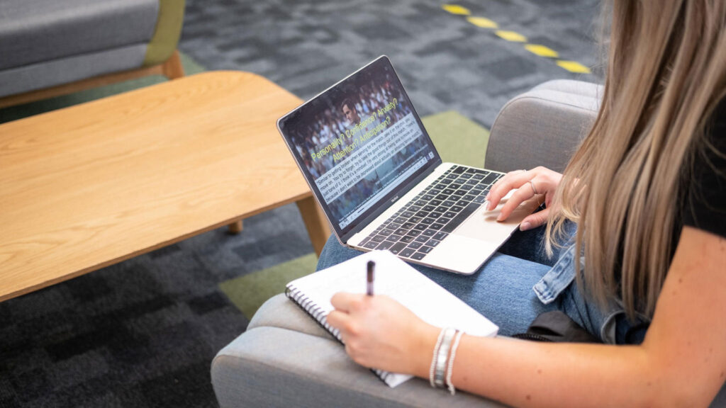 A student watching a lecture remotely online 